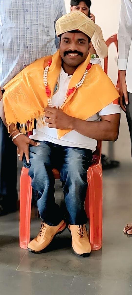 Ajit Padasalagi seated in traditional attire and turban during a ceremony