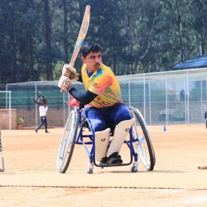 Hareesh Kumar at the crease with the bat raised