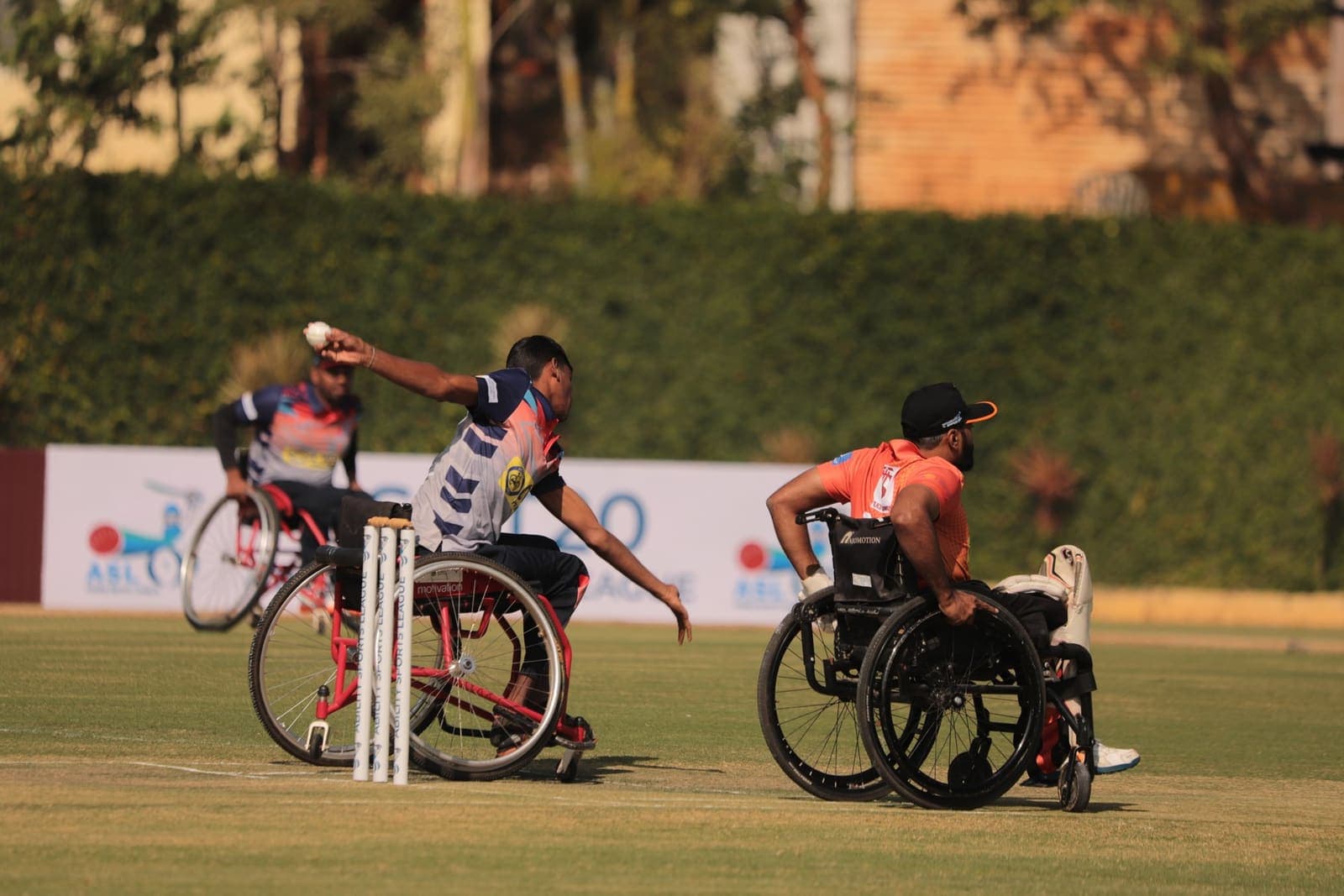 Mallikarjun V S bowling during a wheelchair cricket match