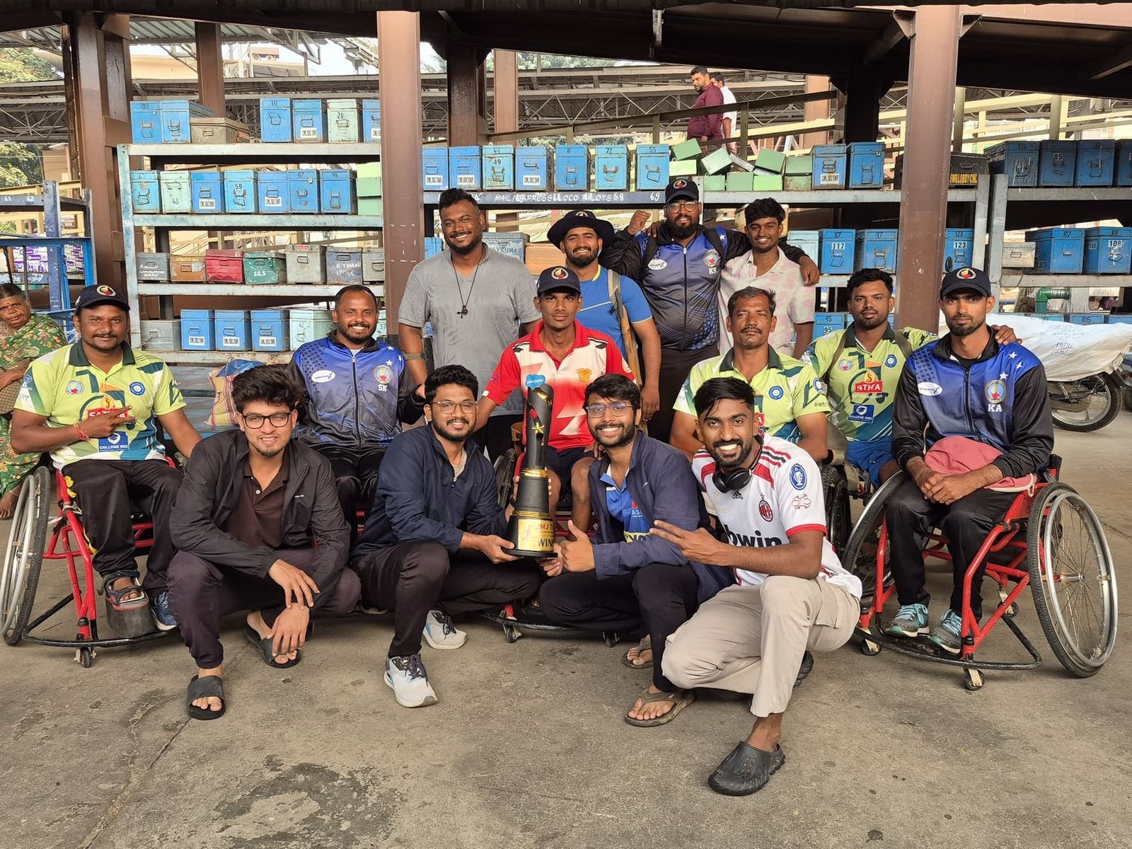 Mallikarjun V S with teammates and volunteers holding a trophy