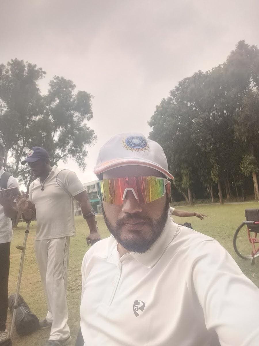 Mohammed Umar Manna in sunglasses and a cap at the ground