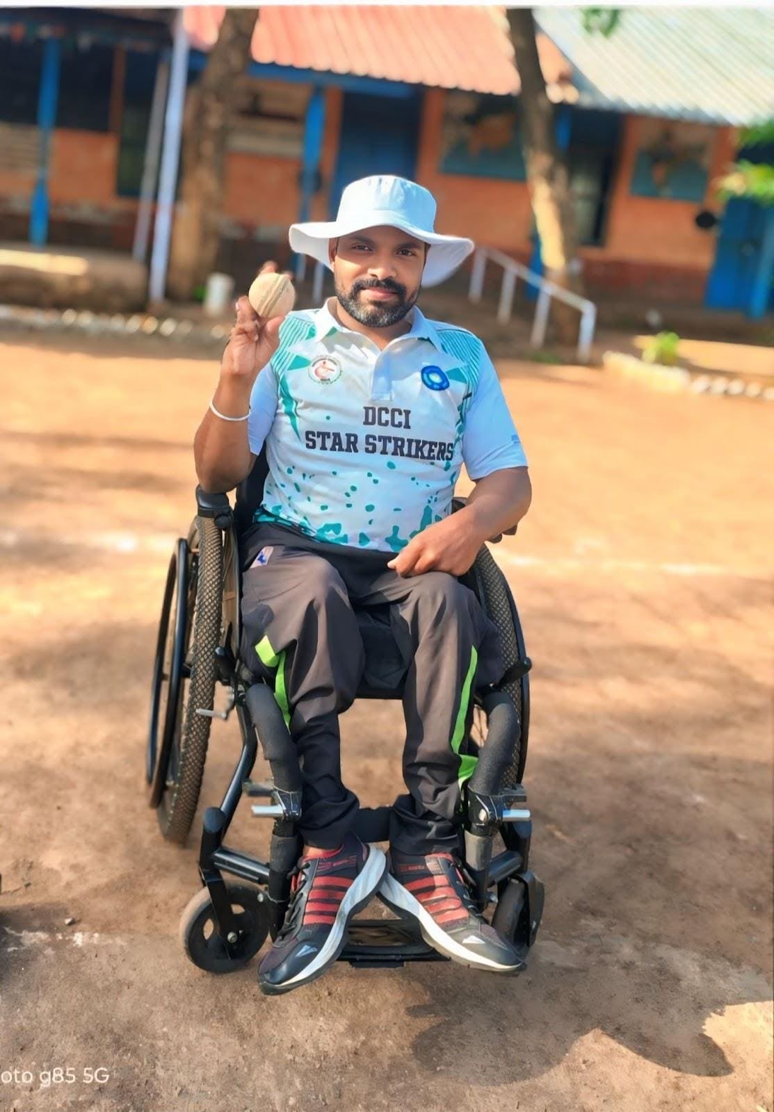 Ajit Padasalagi seated in a sports wheelchair holding a ball