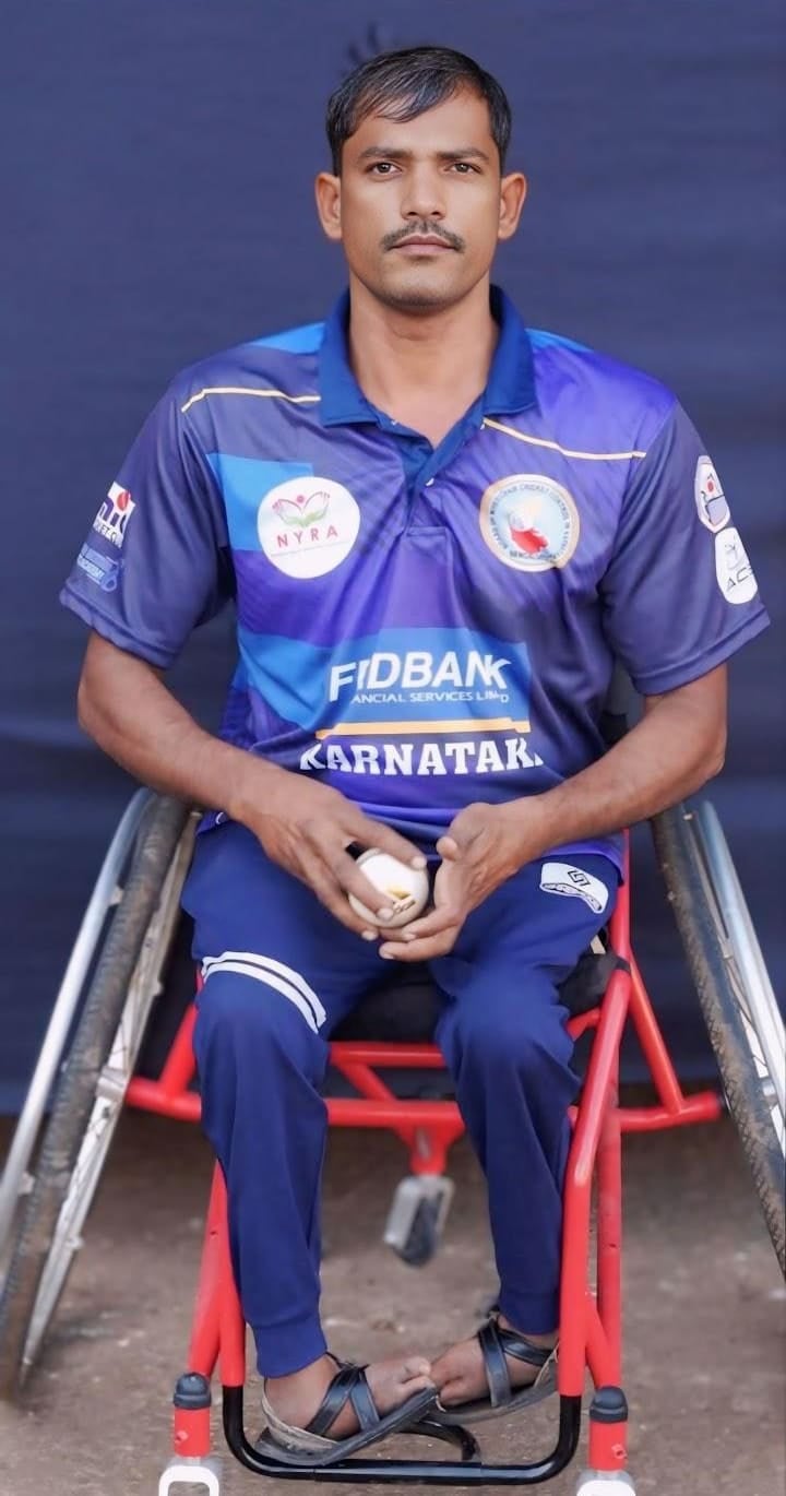 Bharatesh B Mahishwadagi in a Karnataka jersey, holding a ball in a sports wheelchair