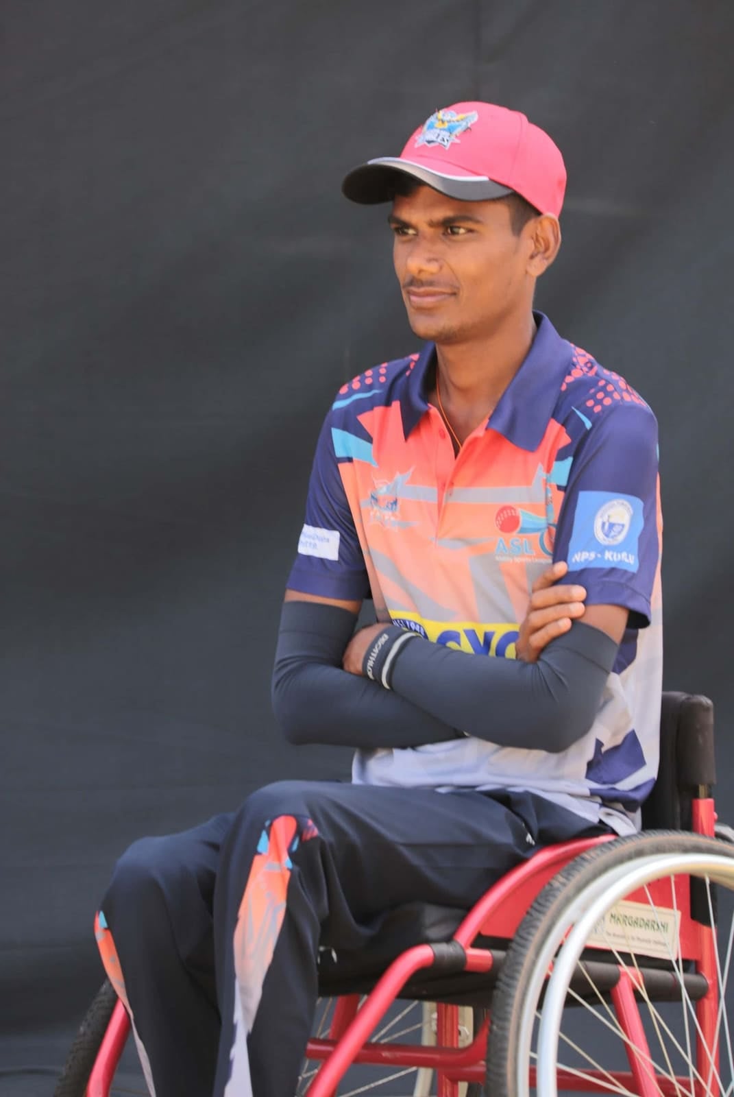 Portrait of Mallikarjun V S in a team jersey and pink cap
