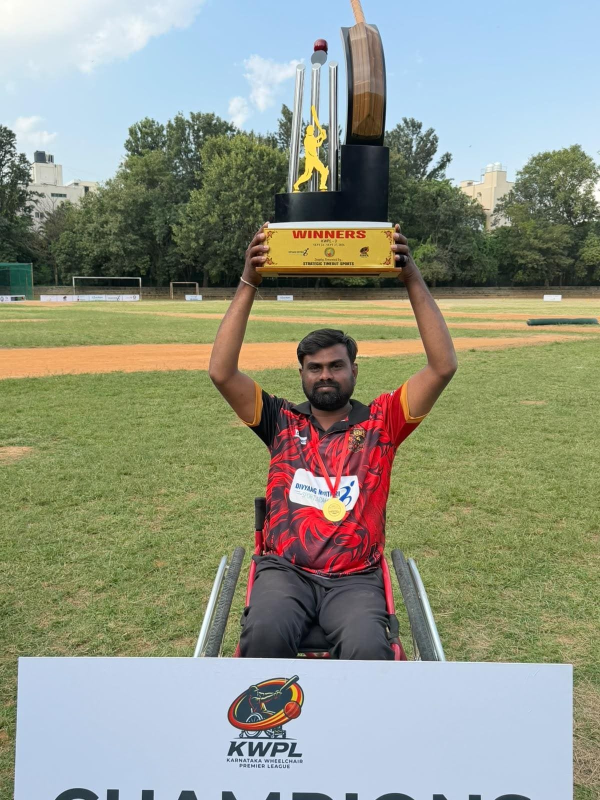 Sunil C V lifting the KWPL winners' trophy overhead