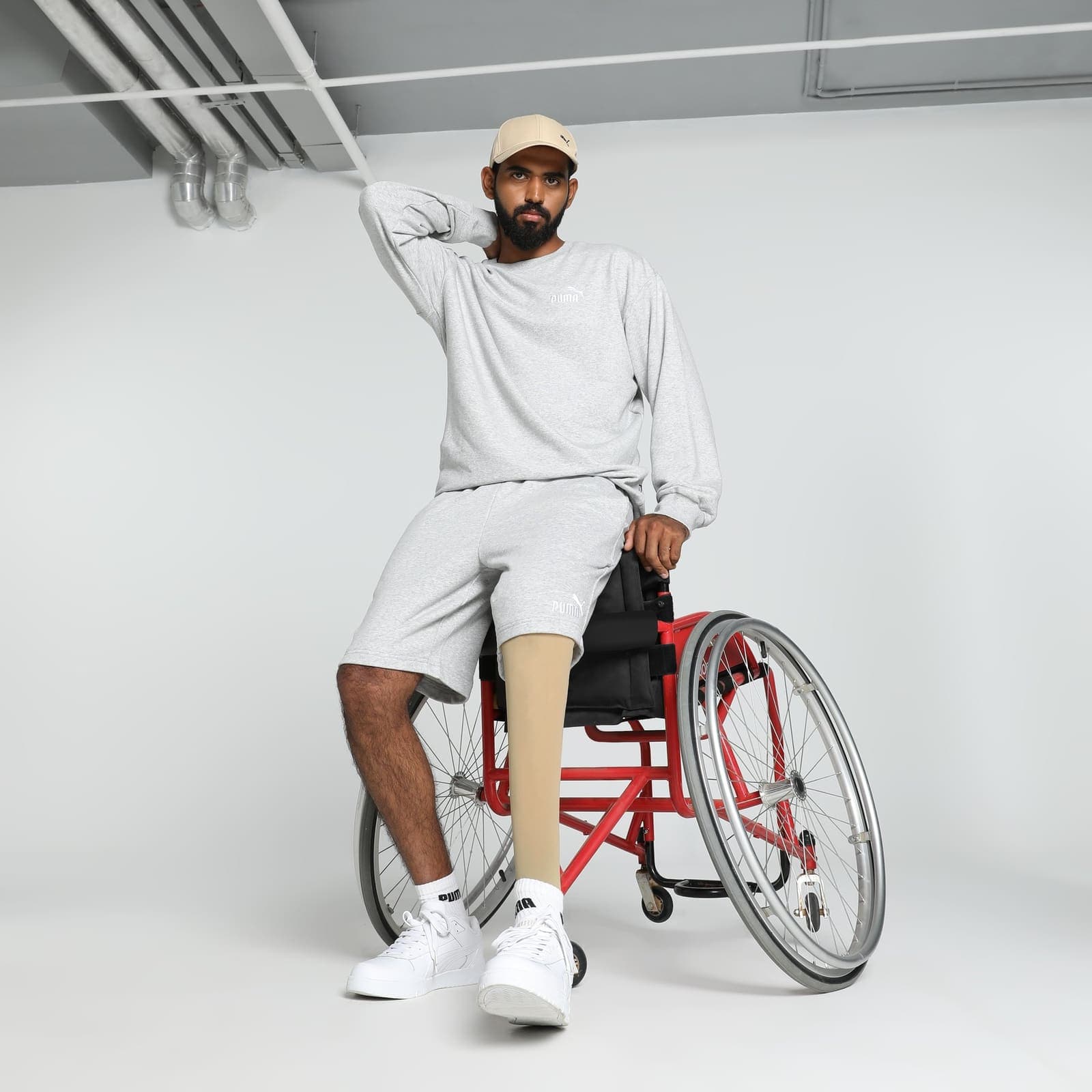 Studio portrait of Sagar BR seated in a sports wheelchair